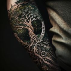 a man's arm with an intricate tree and moon tattoo design on the sleeve