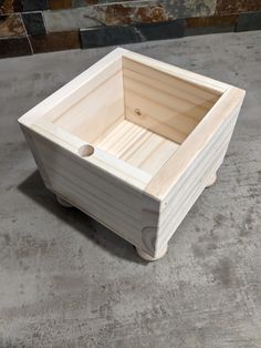 a wooden box sitting on top of a cement floor