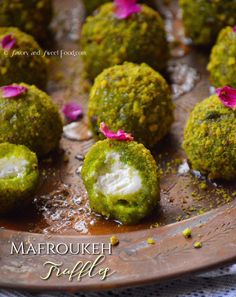 some food that is sitting on a metal plate and has pink flowers in the middle