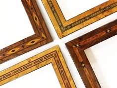 four wooden frames with decorative designs on the edges and sides, all in different sizes