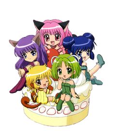 anime characters sitting on top of a cake