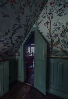 an open door in the corner of a room with floral wallpaper on the walls