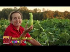 a woman in a red shirt holding up a green plant