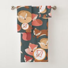 two towels hanging on a towel rack with monogrammed foxes and hearts printed on them