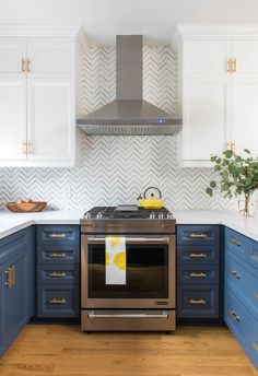 a stove top oven sitting inside of a kitchen next to blue cabinets and counter tops