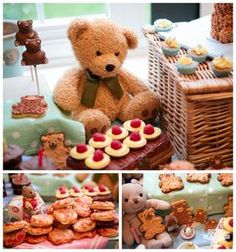 a teddy bear sitting on top of a table next to cakes and pastries in front of a basket