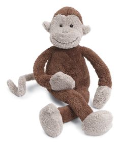 a stuffed monkey sitting on the ground