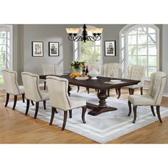 a dining room table with chairs and a chandelier