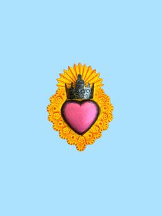 a heart with a crown on it sitting in the middle of a blue sky background