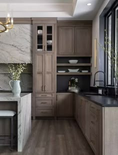 a kitchen with wooden cabinets and marble counter tops