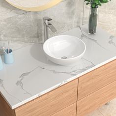 a white bowl sink sitting on top of a bathroom counter next to a vase with flowers