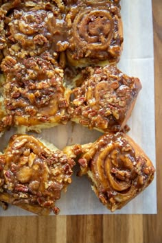 some cinnamon rolls sitting on top of a cutting board