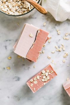 three bars of pink soap with oats on the top and one bar is made from almonds