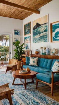 a living room with blue couches and pictures on the wall above them, along with other furniture