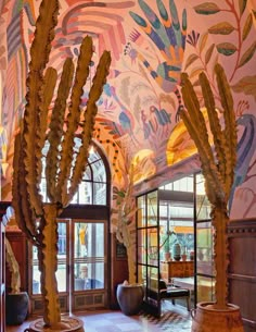 an artisticly decorated lobby with large cactus sculptures