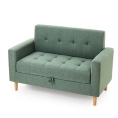 a green couch sitting on top of a white floor