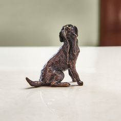 a dog figurine sitting on top of a white counter next to a wall