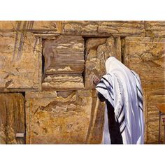 a man standing in front of a stone wall