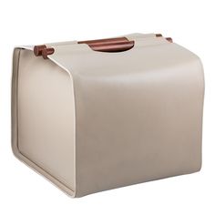 a white leather suitcase with brown handles