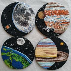 four coasters with different pictures of the earth and stars on them, all made out of fabric