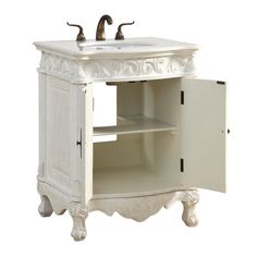 a white bathroom sink sitting under a faucet on top of a wooden cabinet