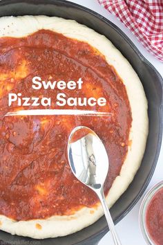 a pizza in a skillet with the words sweet pizza sauce on it and a spoon next to it