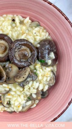 a pink bowl filled with rice and mushrooms