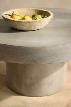 a bowl sitting on top of a cement table