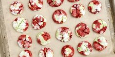 red velvet cookies covered in powdered sugar on a baking sheet, ready to go into the oven