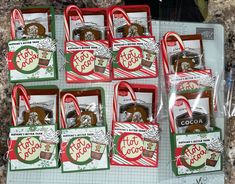 six bags of assorted holiday goodies are on display in the package bag holder