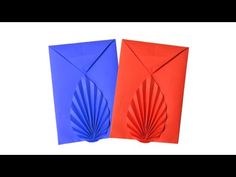 two red and blue envelopes with folded paper in the shape of an origami fan