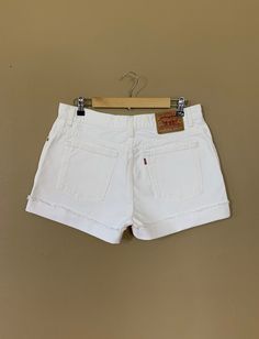 "High waisted 90's denim shorts. Made by Levi's Jeans in classic white denim wash. Shorts are in excellent clean condition. Perfectly worn in with light naturally distressed character. These have been cut off and washed once. Measurements are taken zipped or buttoned up and laid comfortably flat then x 2 for total circumference (inches) Tag Size 12 100% Cotton ~ Measurements taken 'un' rolled Waist 34\" Hips 45.5\" Length 15\" Inseam 4\" Rise 11\" leg opening circumference 26.5\" All items are f Retro White Shorts With Pockets, White High Waist Jean Shorts With Belt Loops, White Cotton Jean Shorts With Belt Loops, Vintage High Waist White Shorts, Vintage White Jean Shorts For Spring, Casual White Jean Shorts With Belt Loops, Vintage White Jean Shorts, Vintage White Cotton Jean Shorts, White Cotton Vintage Jean Shorts