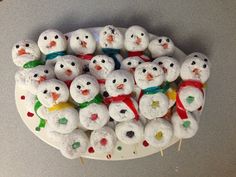 there are many snowmen made out of marshmallows on a plate with toothpicks