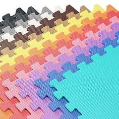 several pieces of colored foam puzzle are arranged in rows on top of eachother