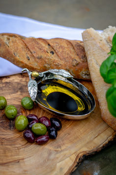 olives and bread on a wooden cutting board