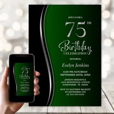 a person holding up a smart phone in front of a green and black birthday card