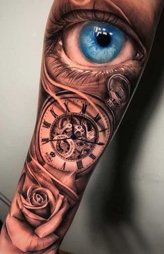 an eye with a clock and rose tattoo on the arm