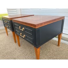 two black and brown dressers sitting on top of each other