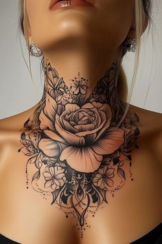 a woman's neck is adorned with black and white flowers