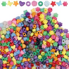 a pile of colorful plastic beads on a white background