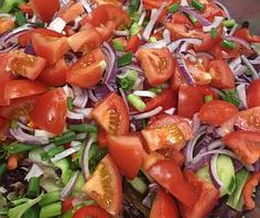 a salad with tomatoes, onions and green peppers on it is shown in a bowl