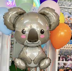 a koala bear balloon with balloons in the background