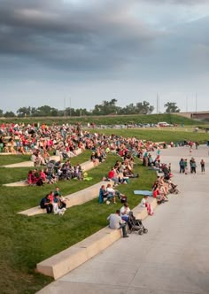 a large group of people sitting on the grass