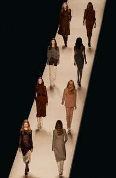 a group of women walking down a runway