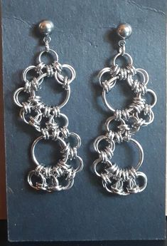 the earrings are made out of silver wire and have circular links on each earring