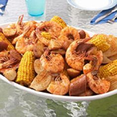 shrimp and corn on the cob in a bowl