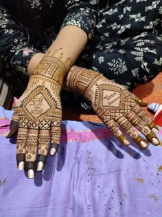 two hands with henna designs on them