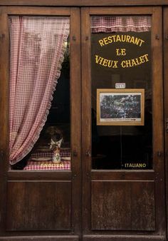 a restaurant window with a teddy bear in it