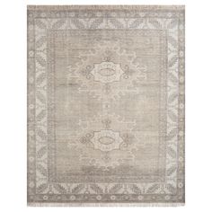 an antique rug with grey and beige colors