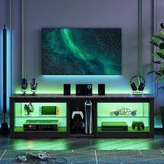 an entertainment center with speakers and lights on the wall, in front of a large painting